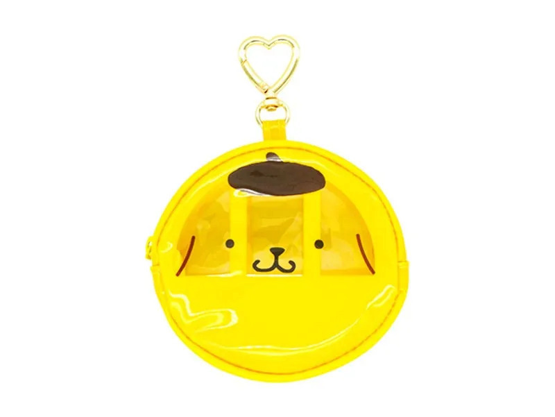 白い背景に、サンリオの人気キャラクター「ポムポムプリン」の顔がデザインされた、黄色い丸型の透明なコインケースです。上部にはハート型のキーホルダー金具が付いています。