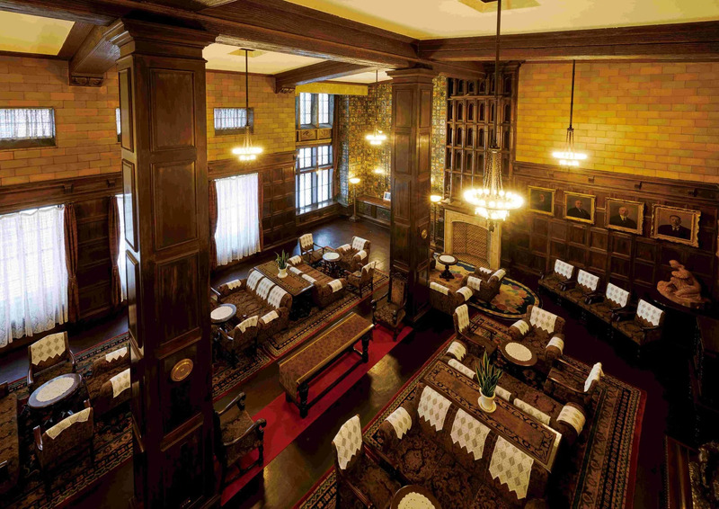 広い部屋の俯瞰写真。木製のパネルと梁で装飾されており、大きな柱が立っている。