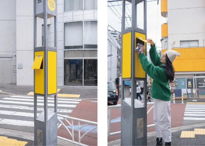 女性が街の黄色いポストに手紙を入れる様子